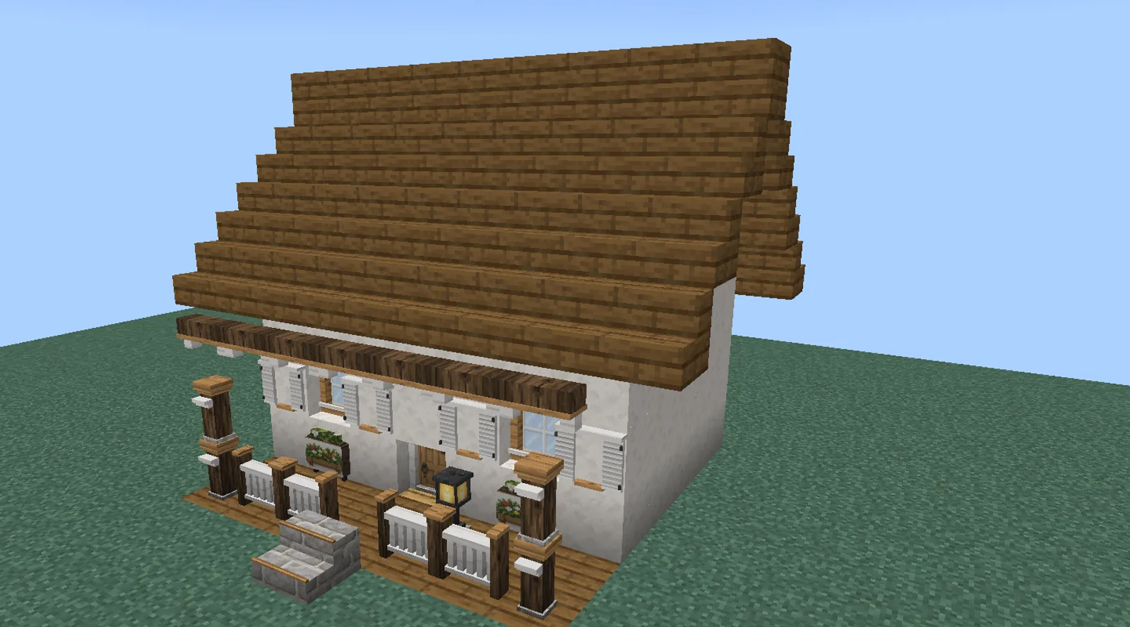 A small Minecraft house with whitewashed plaster walls, a spruce roof, a front door between shuttered windows and a porch with posts and railings
