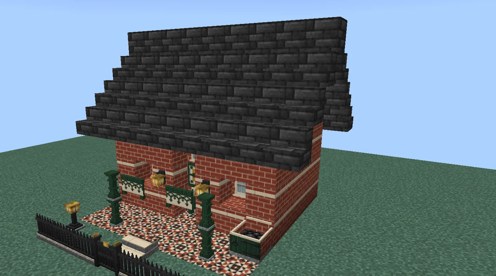 A Minecraft Victorian house in banded red brick with a dark tiled roof, a paneled front door with a stained glass transom, a porch with turned posts and an iron railing